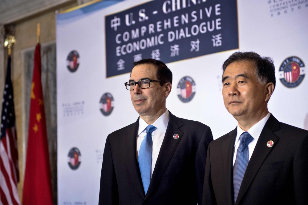 (FILES) In this file photo taken on July 19, 2017, US Treasury Secretary Steven Mnuchin (L) and Chinese Vice Premier Wang Yang pose for a photo before an opening session at the US and China comprehensive Economic Dialogue at the US Department of the Treas