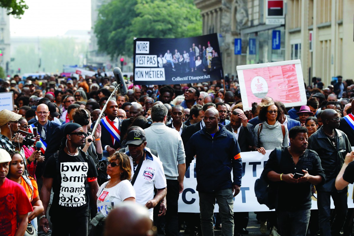 People hold a banner reading 