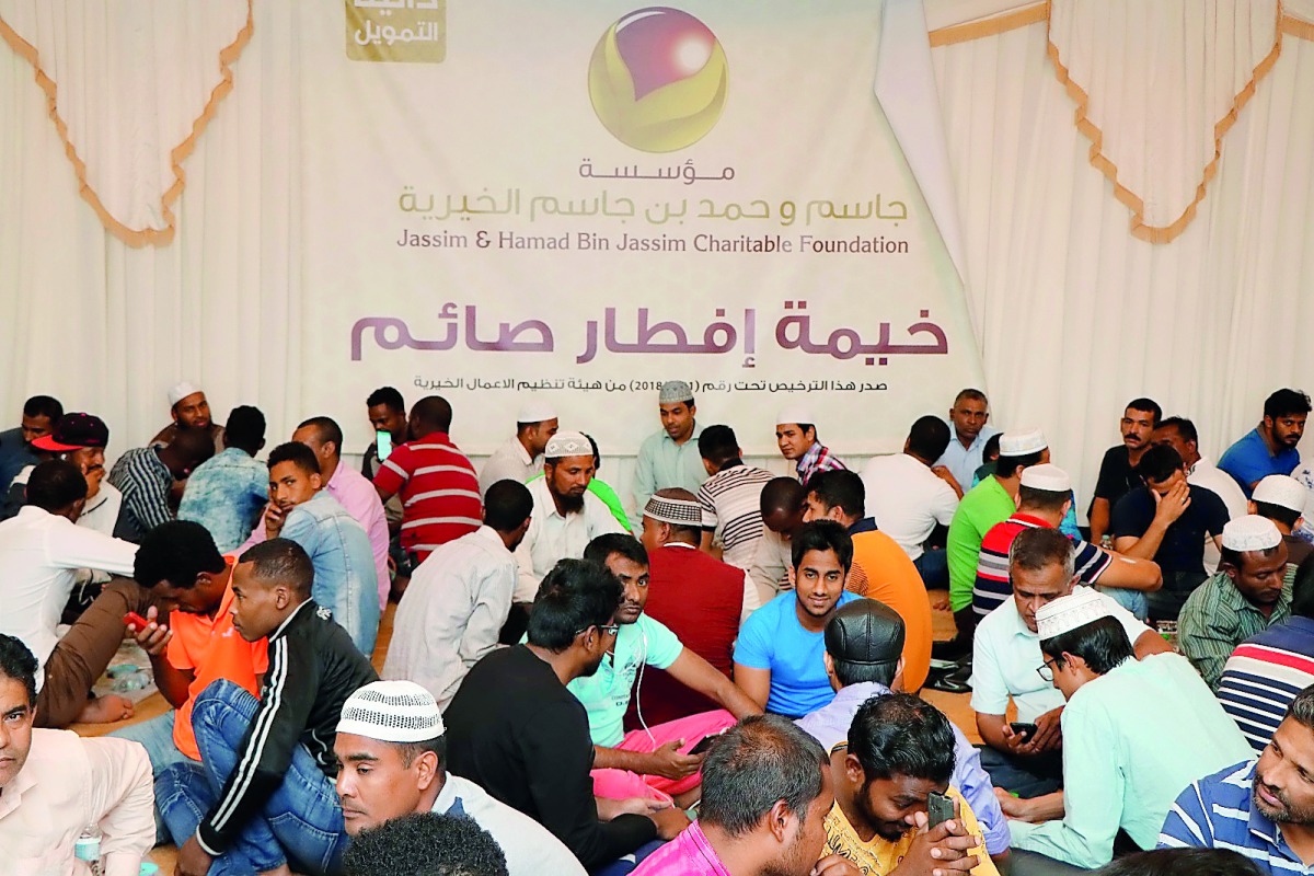 Fasting people having Iftar meals at HBJ Foundation tent.