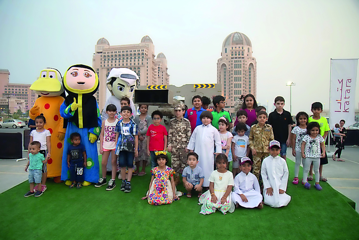 Children pose for photo with mascots at the Meerat Ramadan at Katara.