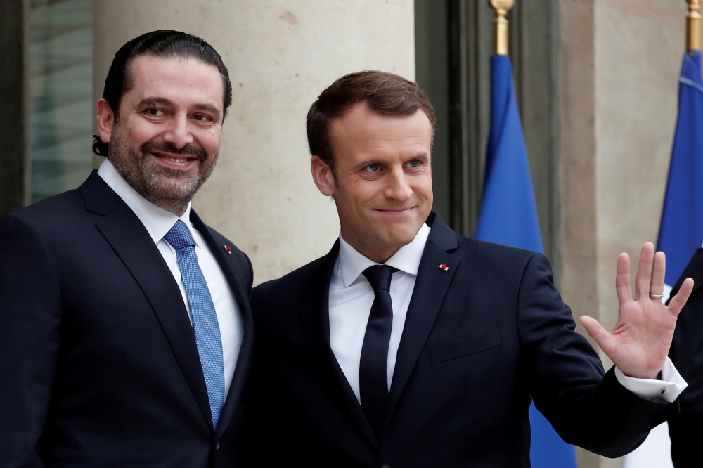 File photo: French President Emmanuel Macron and Saad al-Hariri react on the steps of the Elysee Palace in Paris, France, November 18, 2017. Reuters/Benoit Tessier/File Photo