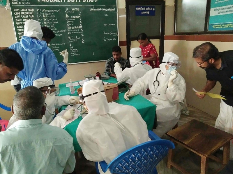 Medical personnel wearing protective suits check patients at the Medical College hospital in Kozhikode on May 21, 2018. (AFP) 