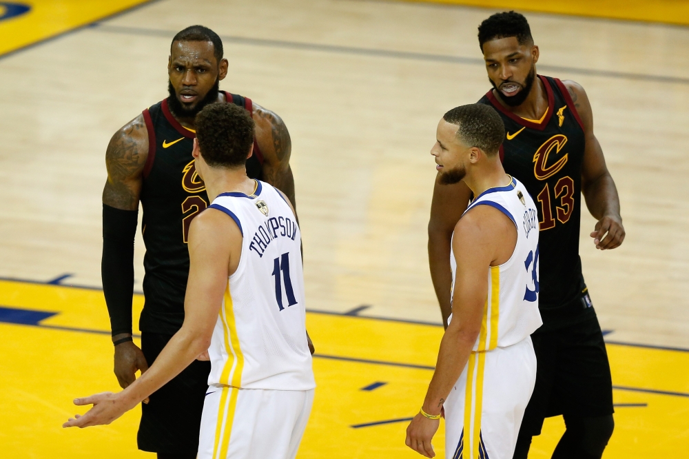 LeBron James #23 and Tristan Thompson #13 of the Cleveland Cavaliers exchange words with Klay Thompson #11 and Stephen Curry #30 of the Golden State Warriors in overtime during Game 1 of the 2018 NBA Finals at ORACLE Arena on May 31, 2018 in Oakland, Cali