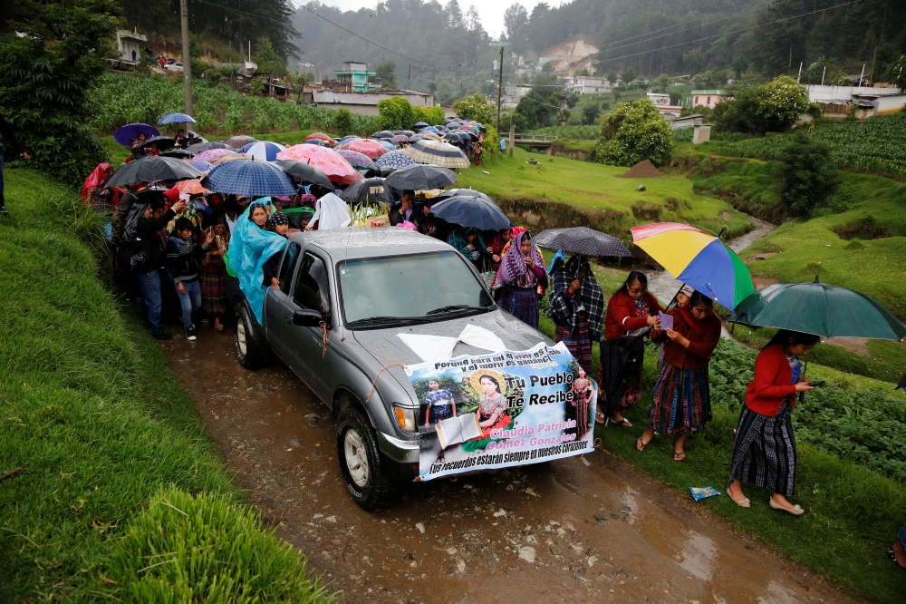 Relatives and friends of Claudia Gomez, a 19-year old Guatemalan immigrant who was shot by a U.S. Border Patrol officer, take part in her funeral procession towards a cemetery in San Juan Ostuncalco, Guatemala June 2, 2018. Reuters/Luis Echeverria 