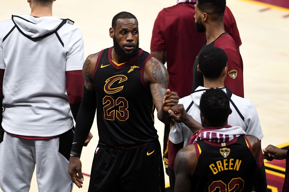 LeBron James #23 of the Cleveland Cavaliers reacts with Jeff Green #32 late in the game against the Golden State Warriors during Game Four of the 2018 NBA Finals at Quicken Loans Arena on June 8, 2018 in Cleveland, Ohio.  Jason Miller/Getty Images/AFP 