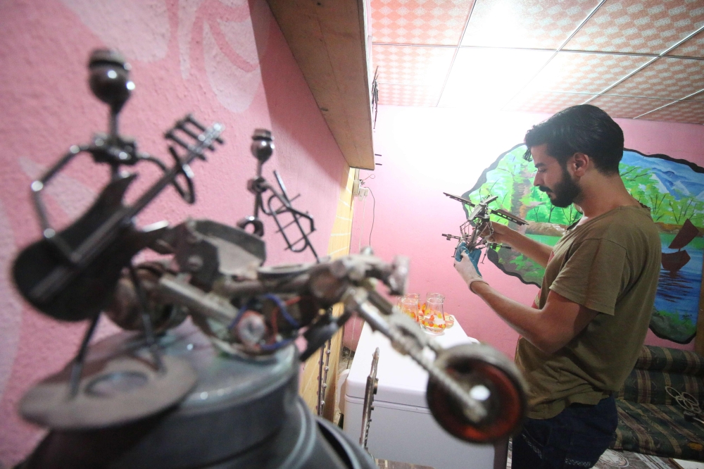 Iraqi Omar Abdallah operates at his workshop in Basra on June 17, 2018. AFP / Haidar MOHAMMED ALI 