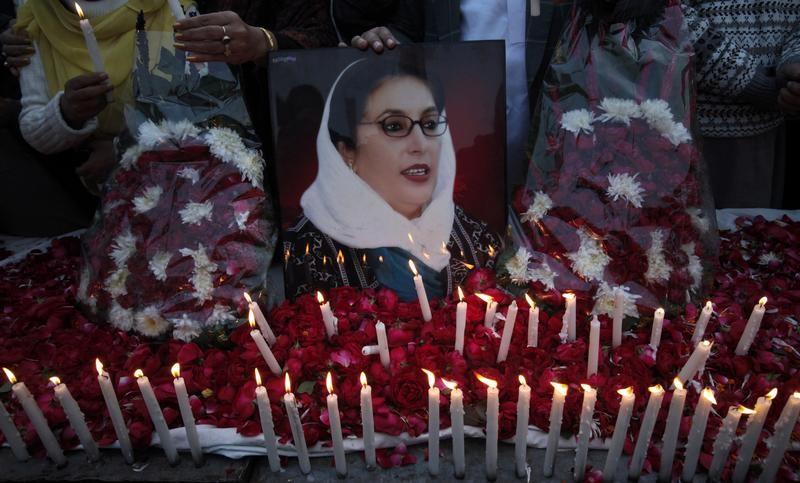 Supporters of Pakistan People's Party hold an image of Pakistan's former prime minister Benazir Bhutto during a candlelight vigil to commemorate her death anniversary in Lahore December 26, 2011. Reuters/Mohsin Raza