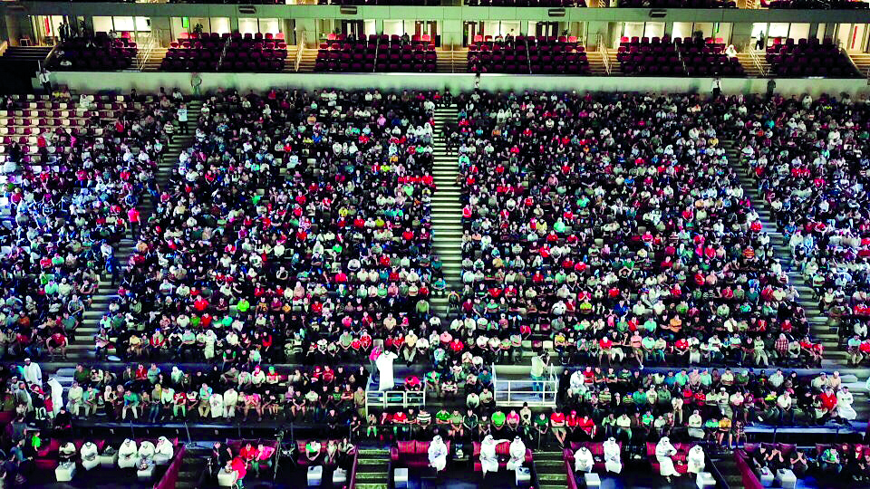 Football fans attend a match at the Khalifa International Stadium.