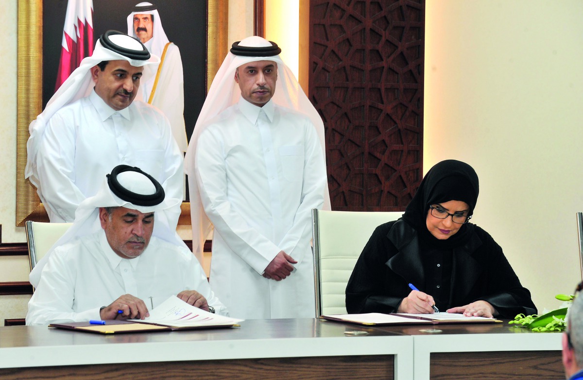 Ibrahim Abdullah Al Qubaisi (sitting left), the Director of the Judicial Inspection Department at the Public Prosecution, and Amal Abdullatif Al Mannai (sitting right), CEO of QFSW, accompanied by H E Dr Ali bin Fetais Al Marri (left), the Attorney-Genera