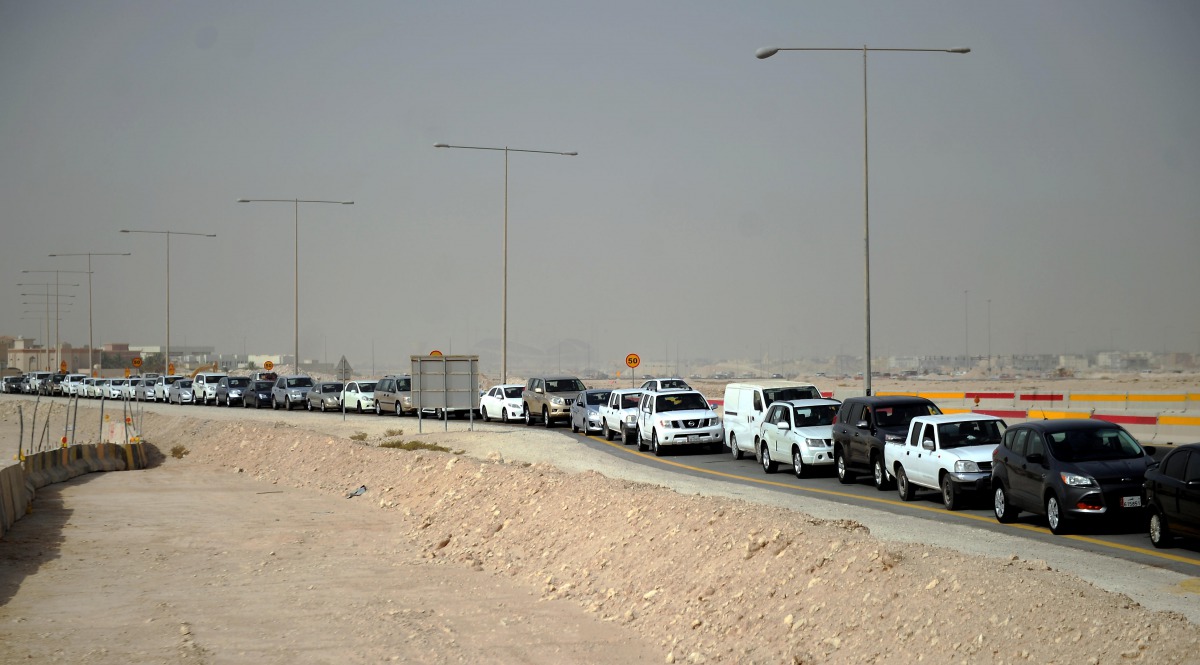 Cars waiting outside the Fahes outlet in Wakra yesterday. (Abdul Basit / The Peninsula)