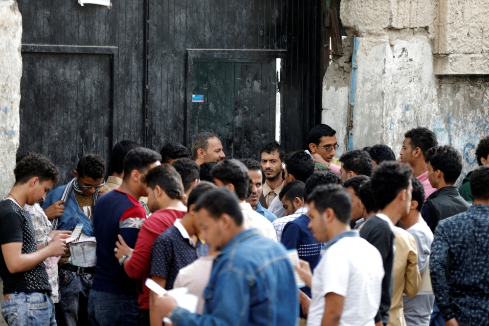 Students including some who have been displaced by the fighting in the Red Sea city of Hodeidah wait at the gate of a school where they take their high school exam away from home in the Houthi-held capital Sanaa, Yemen June 30, 2018. Reuters/Khaled Abdull