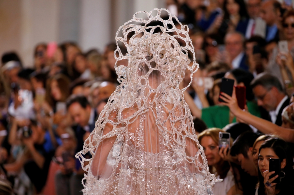 A model presents a wedding dress by designer Elie Saab as part of his Haute Couture Fall/Winter 2018/2019 fashion show in Paris, France, July 4, 2018. Reuters/Regis Duvignau