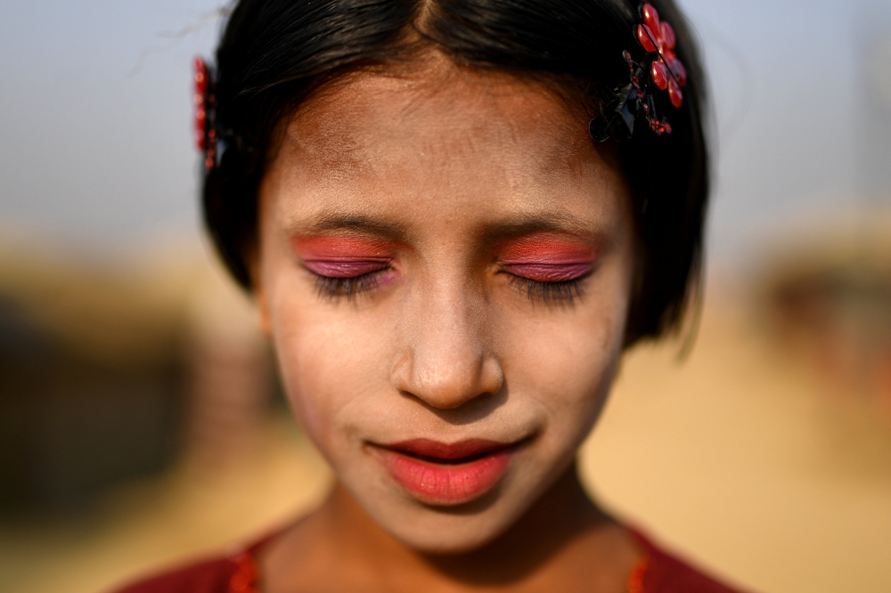 A Rohingya refugee girl named Amina poses for a photograph as she wears thanaka paste at Kutupalong camp in Cox's Bazaar, Bangladesh, March 30, 2018. Reuters/Clodagh Kilcoyne