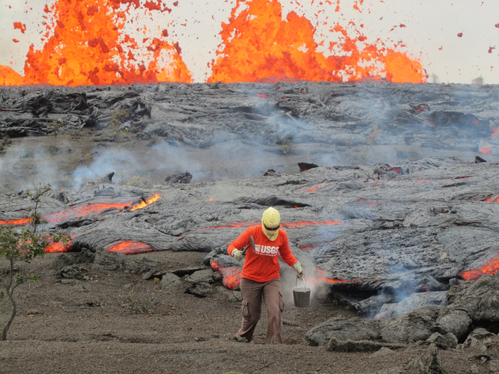 A geologist is collecting sample of molten lava from 2011 Kamoamoa eruption, at Kilauea Volcano, Hawaii, U.S.  USGS/Handout via Reuters