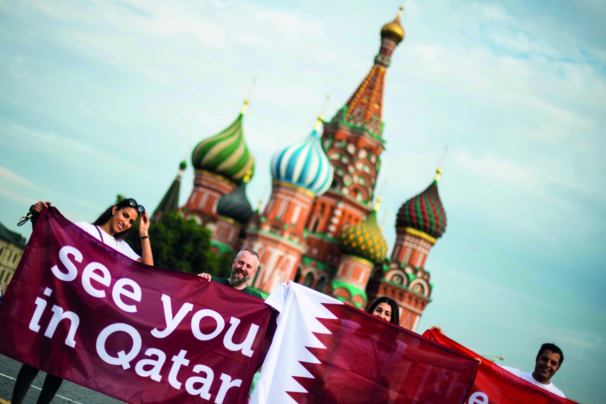 Football fans display a banner reading “See you in Qatar” in reference to the Qatar 2022 World Cup at the Red Square in Moscow, yesterday.