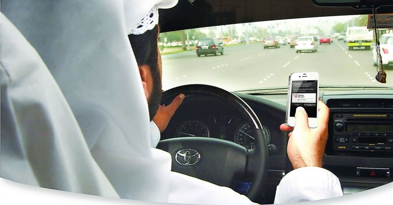 A motorist using mobile phone while driving.