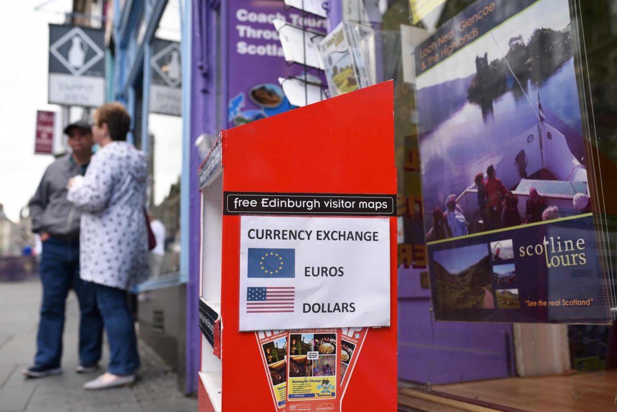 FILE PHOTO: A travel agent on the Royal Mile offers a currency exchange service in Edinburgh on June 25, 2016 following the pro-Brexit result of the EU referendum vote (AFP) 