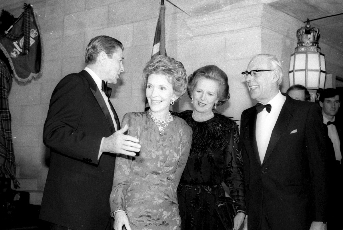 US President Ronald Reagan and Nancy Reagan escort Margaret Thatcher and husband Dennis to the British Embassy in Washington in this February 20, 1985 file photo. Reuters/Charles Cancellare

