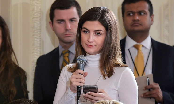 In this file photo taken on February 13, 2017 The Daily Caller White House correspondent Kaitlan Collins (Mic in hand) asks a question during a press conference by US President Donald Trump and Canada's Prime Minister Justin Trudeau in the East Room of th