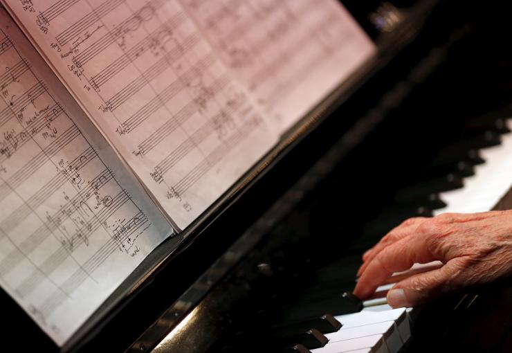 FILE PHOTO: Gyorgy Kurtag, world famous Hungarian composer of classical music and pianist, plays the piano during his 90th birthday celebration in Budapest's Music Center, Hungary February 18, 2016. Reuters/Laszlo Balogh