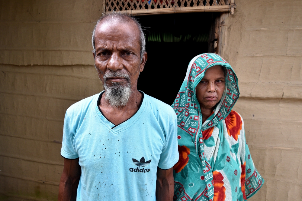 Abdul Suban, a farmer, and his wife pose for a photograph outside their home in Nellie village, in Morigaon district, in the northeastern state of Assam, India July 25, 2018. Picture taken July 25, 2018. Reuters