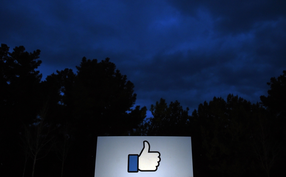 In this file photo taken on March 21, 2018 a lit ‘Like’ sign is seen at the entrance to Facebook's corporate headquarters location in Menlo Park, California on March 21, 2018.  AFP / Josh Edelson
 