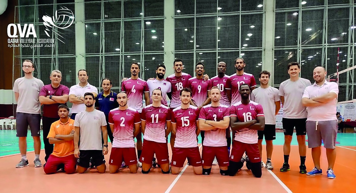 Qatar Volleyball players and team officials pose for a photograph. 