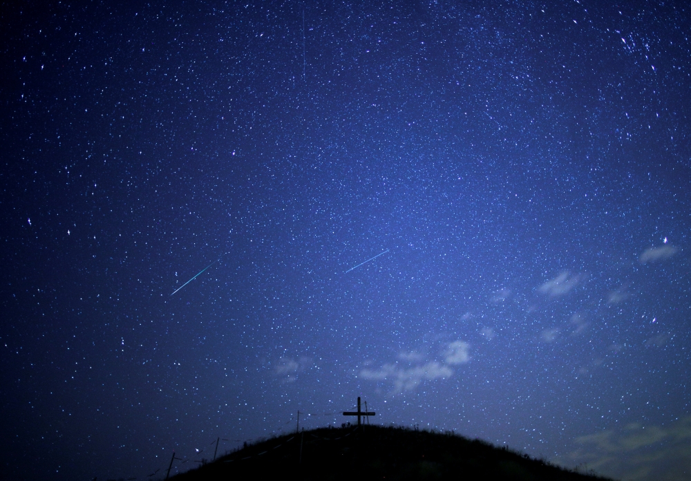 A meteor streaks past stars in the night sky above Leeberg hill during the Perseid meteor shower in Grossmugl, Austria, August 10, 2018. Reuters/Heinz-Peter Bader 