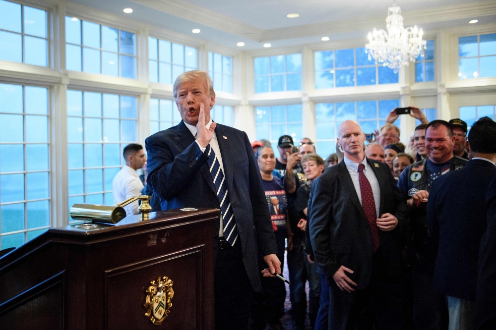 US President Donald Trump makes a comment to the press about former aid Omarosa Manigault Newman while meeting with supporters during a Bikers for Trump event at the Trump National Golf Club August 11, 2018 in Bedminster, New Jersey.  AFP / Brendan Smialo