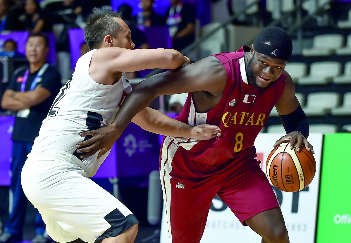 Qatar’s Tanguy Ngombo (right) dribbles past Hong Kong’s Chow Ka Kui in their preliminary Group C game on Tuesday.