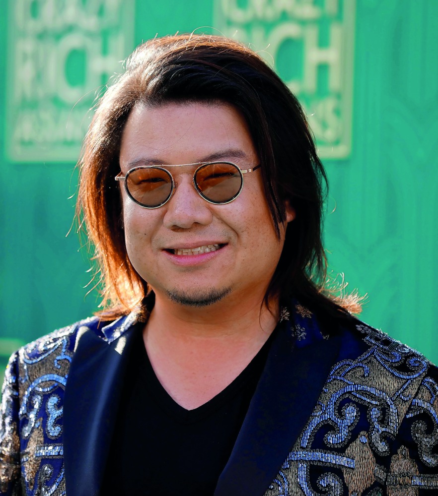 Author Kevin Kwan poses at the premiere for 