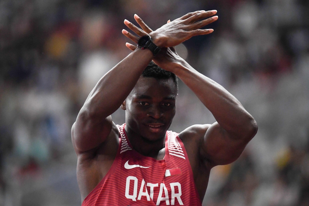 Qatar's Tosin Ogunode reacts after winning a heat of the men's 100m athletics event during the 2018 Asian Games in Jakarta on August 25, 2018. / AFP / Jewel SAMAD