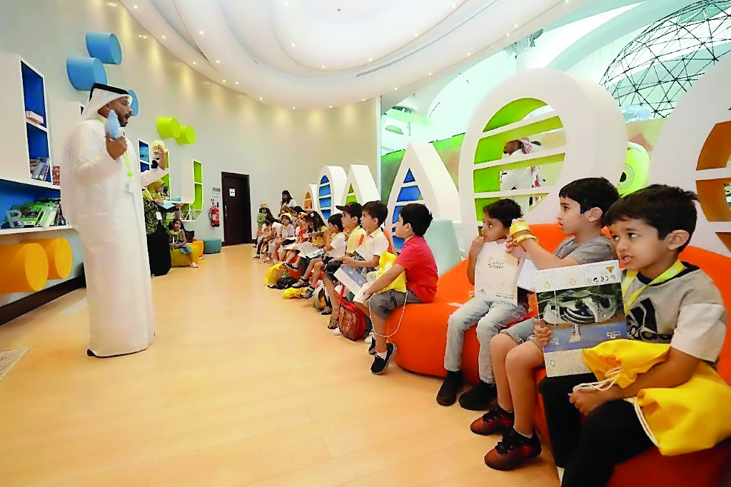 The children are receiving lessons on conservation of electricity and water consumption at Kahramaa Awareness Park.