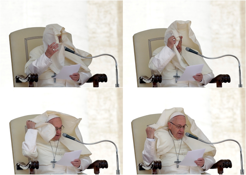 A combination photo shows a gust of wind blowing the mantle Pope Francis during the Wednesday general audience in Saint Peters square at the Vatican, May 16, 2018. (Reuters / Max Rossi) 