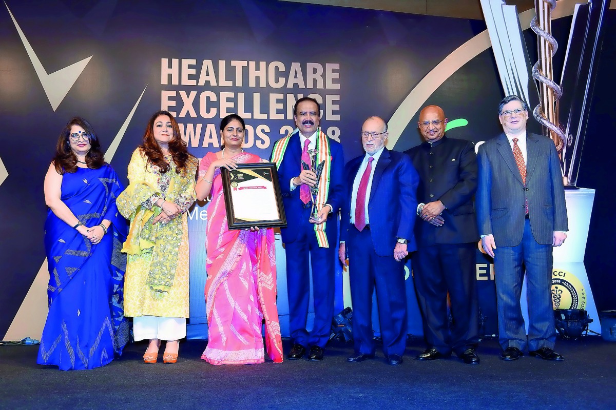 Dr Azad Moopen  (centre) receiving the Lifetime Achievement Award at FICCI Healthcare Excellence Awards.