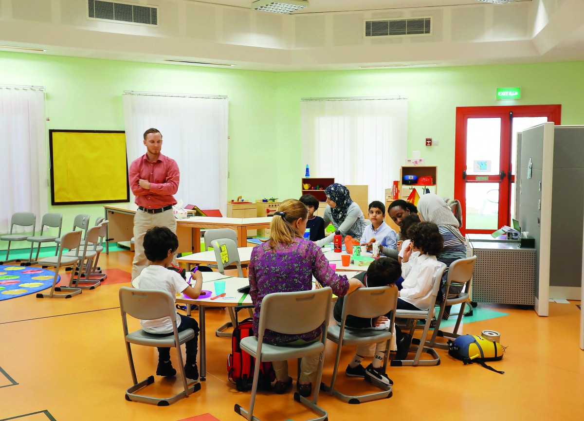 Joseph Norton, lead teacher at Renad Academy, with students during a class. 