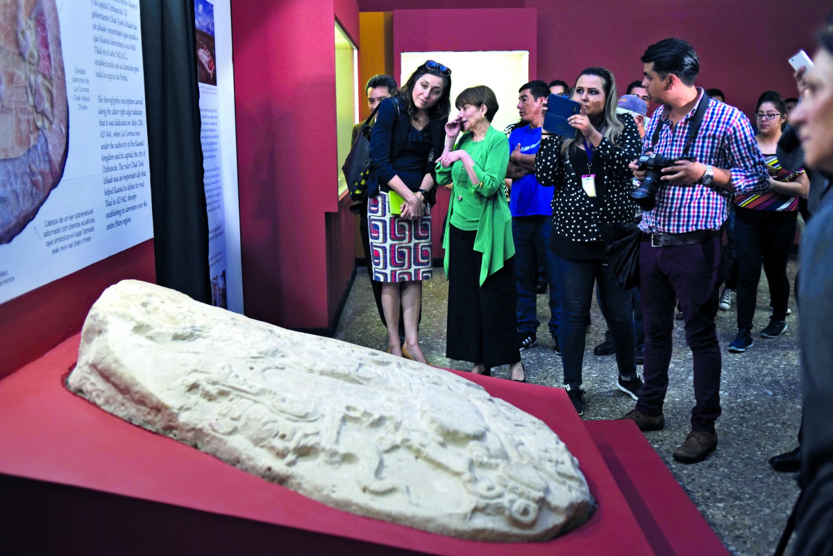 People look at a Mayan altar exhibited at the National Museum of Archaeology and Ethnology in Guatemala City on September 12, 2018. AFP / Johan Ordonez


