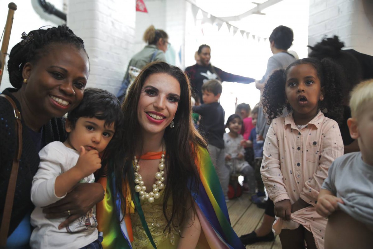 Drag performer Topsy Redfern poses for a photo with members of staff and children at London Early Years Foundation nursery in London, United Kingdom on August 24, 2018. Thomson Reuters Foundation / Cormac O'Brien