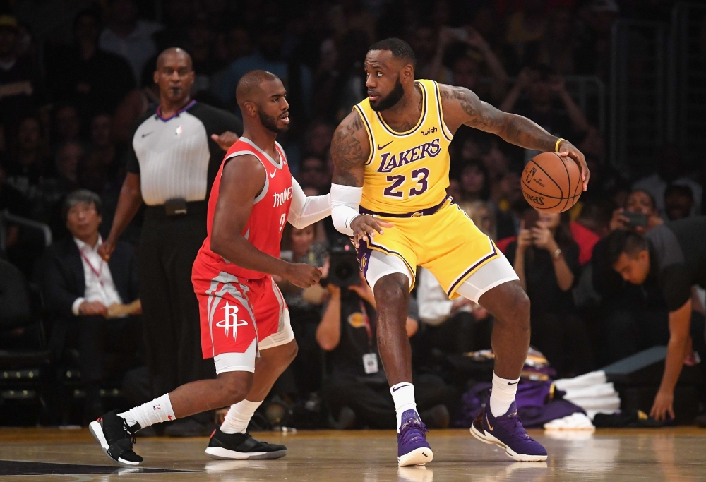 LeBron James #23 of the Los Angeles Lakers dribbles the ball against Chris Paul #3 of the Houston Rockets during the first quarter at Staples Center on October 20, 2018 in Los Angeles, California. Harry How/AFP
