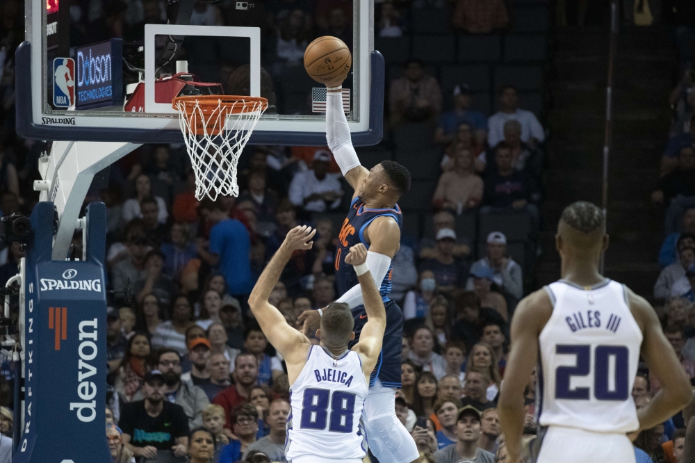 Russell Westbrook #0 of the Oklahoma City Thunder goes over Nemanja Bjelica #88 of the Sacramento Kings for two points during the second half of a NBA game at the Chesapeake Energy Arena on October 21, 2018 in Oklahoma City, Oklahoma. J Pat Carter/AFP