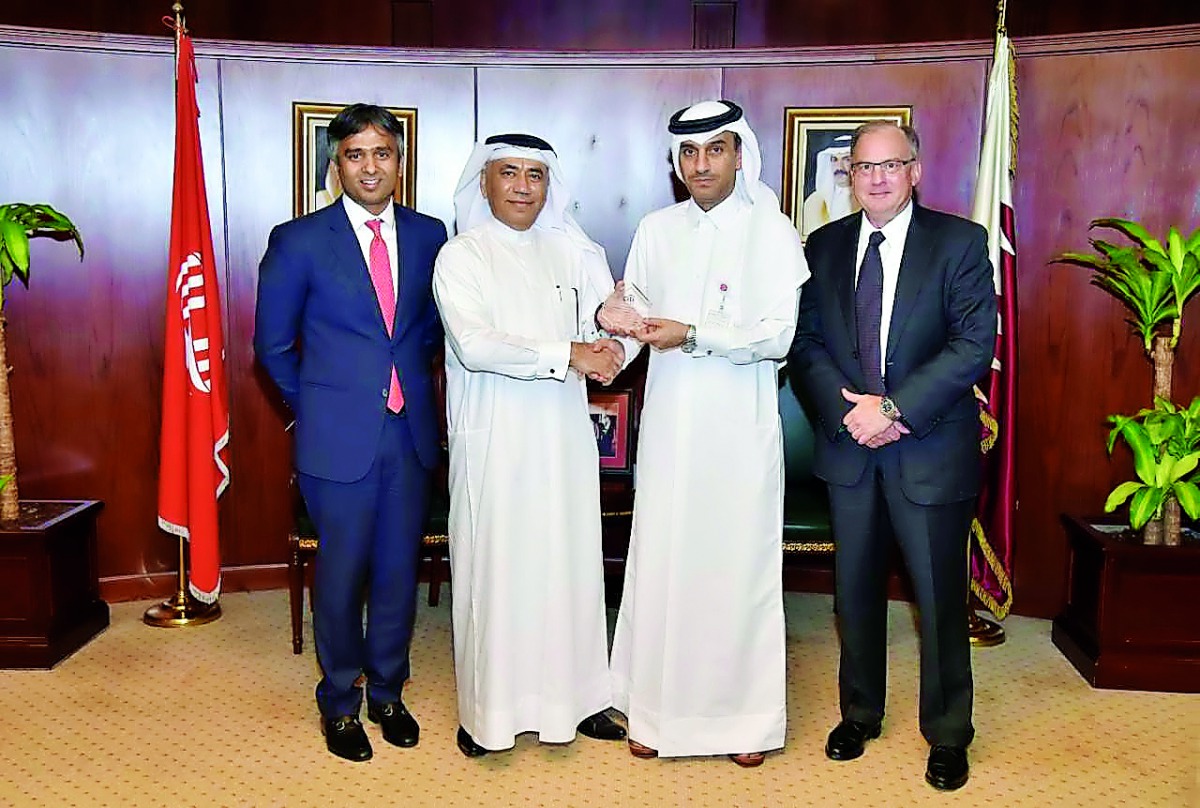 QIIB Deputy CEO Jamal Abdullah Al Jamal (second right) with other officials at QIIB headquarters.