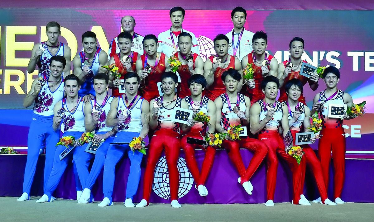 The podium winners of the men’s team event, Chinese, Russian and Japanese gymnasts celebrate after the medal ceremony during the 48th Artistic Gymnastics World Championships Doha 2018 at the Aspire Dome yesterday. Picture: Syed Omar