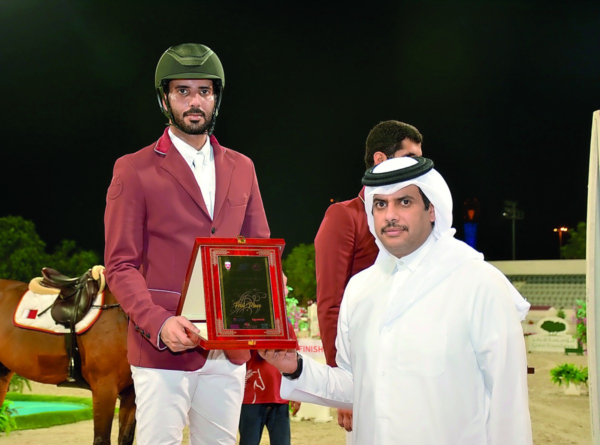 Qatar Equestrian Federation (QEF) President Hamad bin Abdulrahman Al Attiyah presenting the winner’s trophy in the 140cm event to Mubarak Yousuf Al Rumaihi.