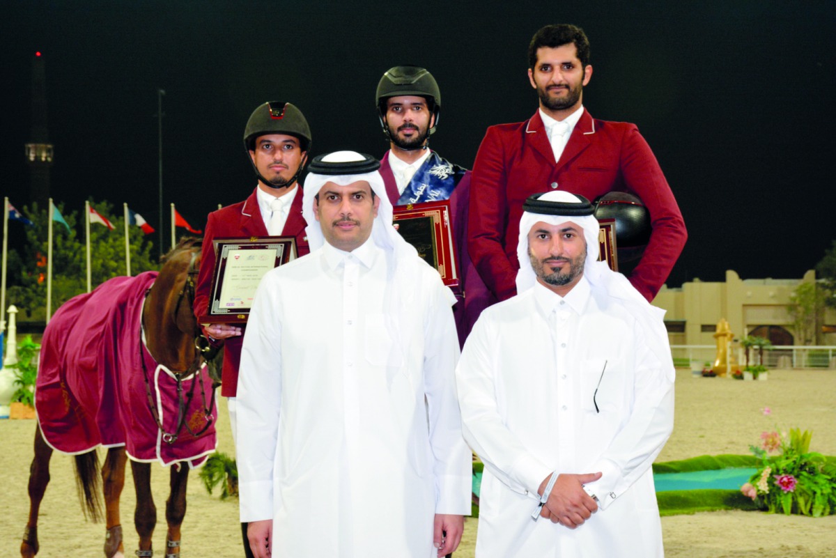 Qatar Equestrian Federation (QEF) President Hamad bin Abdulrahman Al Attiyah and Tournament Director Ali Al Rumaihi pose for a photograph with the podium winners of the Grand Prix at the QEF’s Outdoor Arena yesterday.  