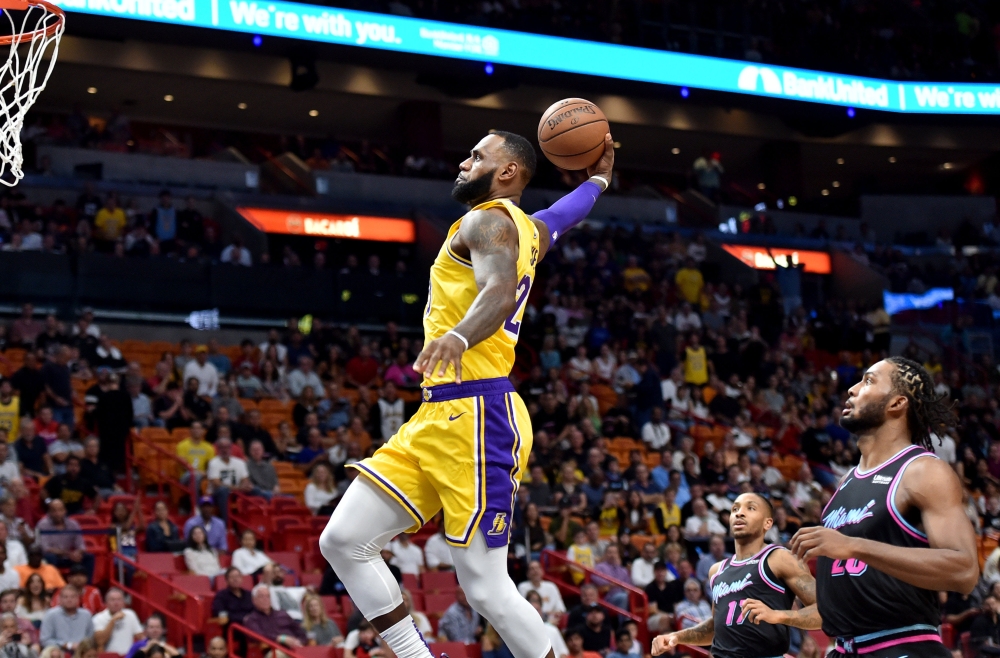 Los Angeles Lakers forward LeBron James (23) dunks beside Miami Heat forward Justise Winslow (20) during the first half at American Airlines Arena. Credit: Steve Mitchell