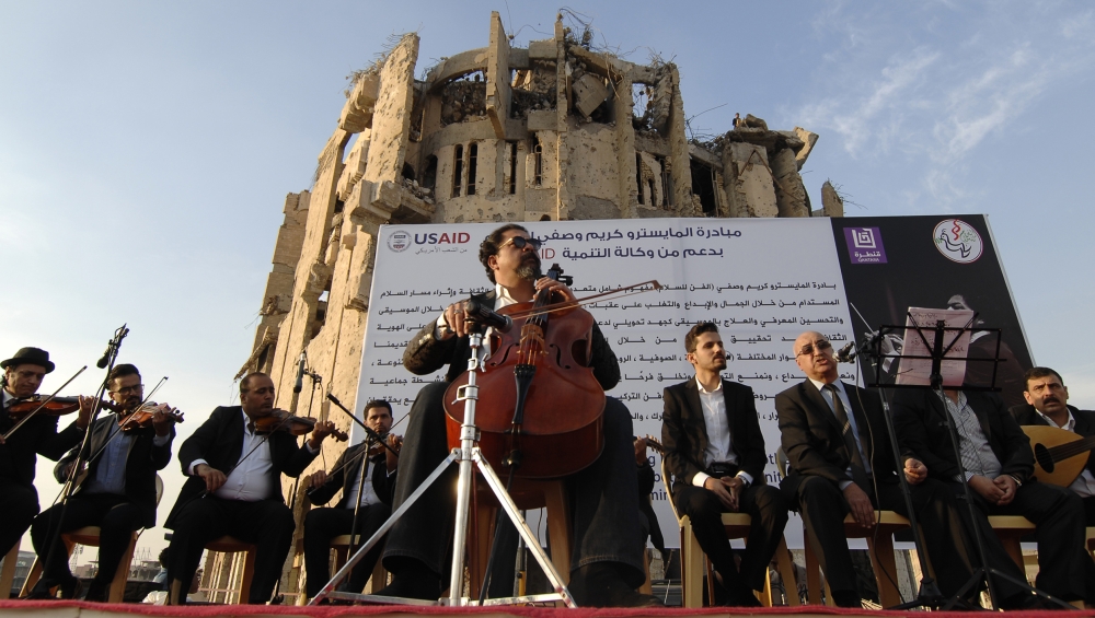 Renowned Iraqi maestro and cello player Karim Wasfi performs in Mosul’s war-ravaged Old City on November 10, 2018. AFP / Zaid AL-OBEIDI 