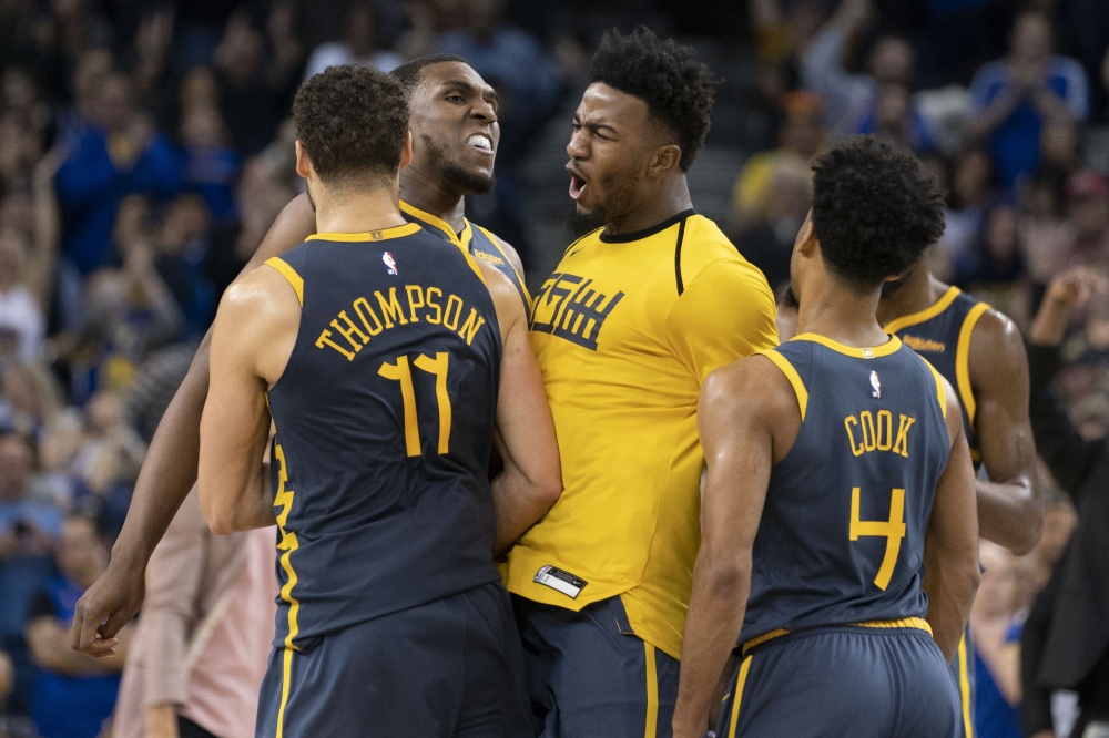 November 24, 2018; Oakland, CA, USA; Golden State Warriors guard Klay Thompson (11) is congratulated by forward Kevon Looney (5), forward Jordan Bell (2), and guard Quinn Cook (4) after making the game-winning basket against the Sacramento Kings during th