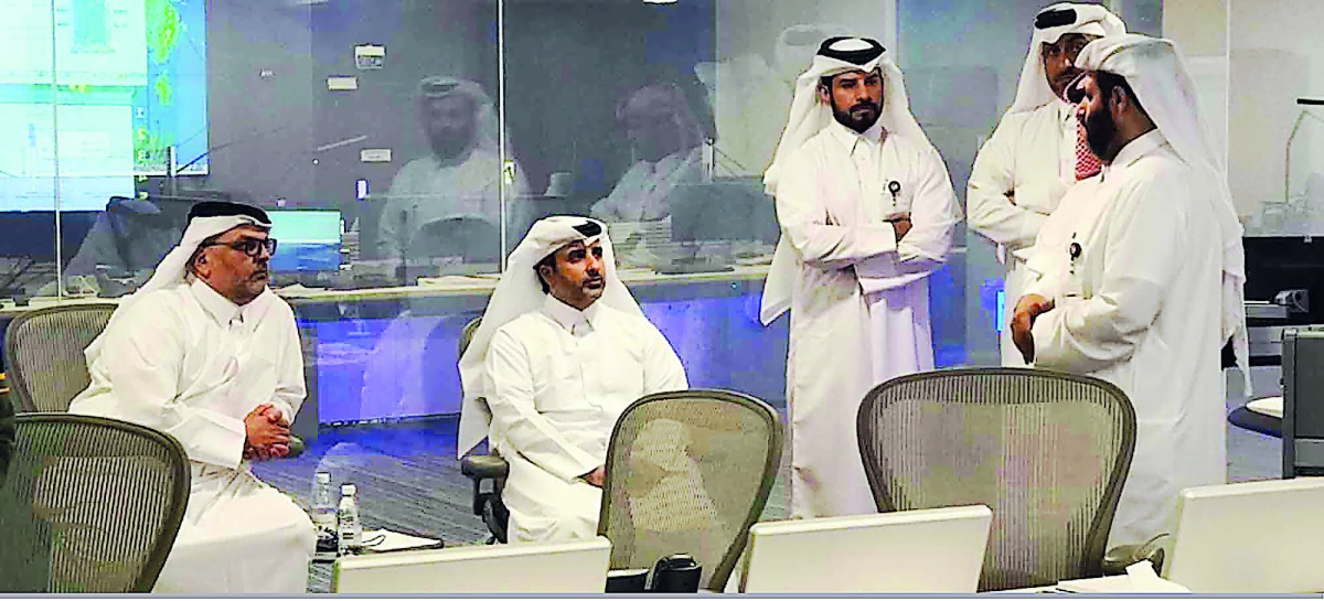 Minister of Municipality and Environment H E Abdullah bin Abdulaziz bin Turki Al Subaie (second left) with President of Ashghal, Eng Saad bin Ahmad Al Muhannadi (left), at the rainfall emergency control room taking stock of the rain situation yesterday.