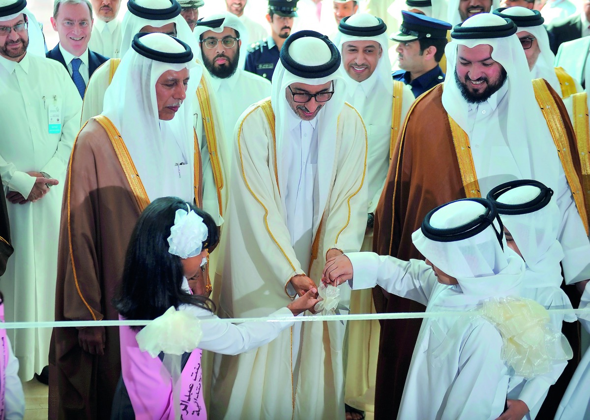 Minister of Culture and Sports H E Salah bin Ghanem Nasser Al Ali (centre) cutting a ribbon with H E Ahmed bin Abdullah bin Zaid Al Mahmoud (left), Speaker of the Advisory Council, Ghaith bin Mubarak Al Kuwari (right), Minister of Awqaf and Islamic Affair