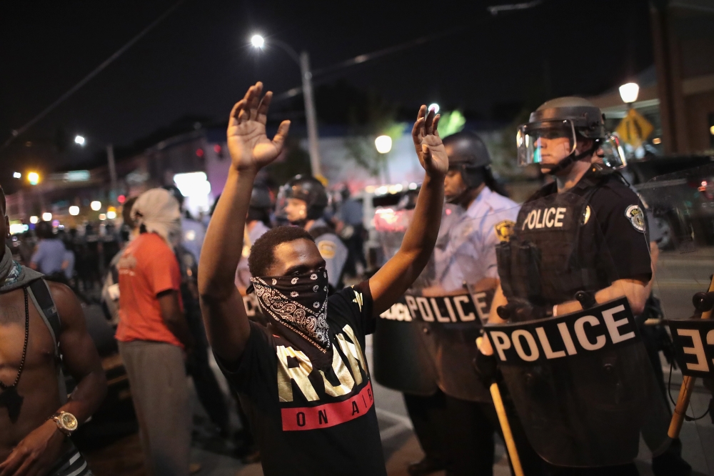 Demonstrators confront police while protesting the acquittal of former St. Louis police officer Jason Stockley in St. Louis, Missouri on September 16, 2017. AFP / Getty Images North America / Scott Olson